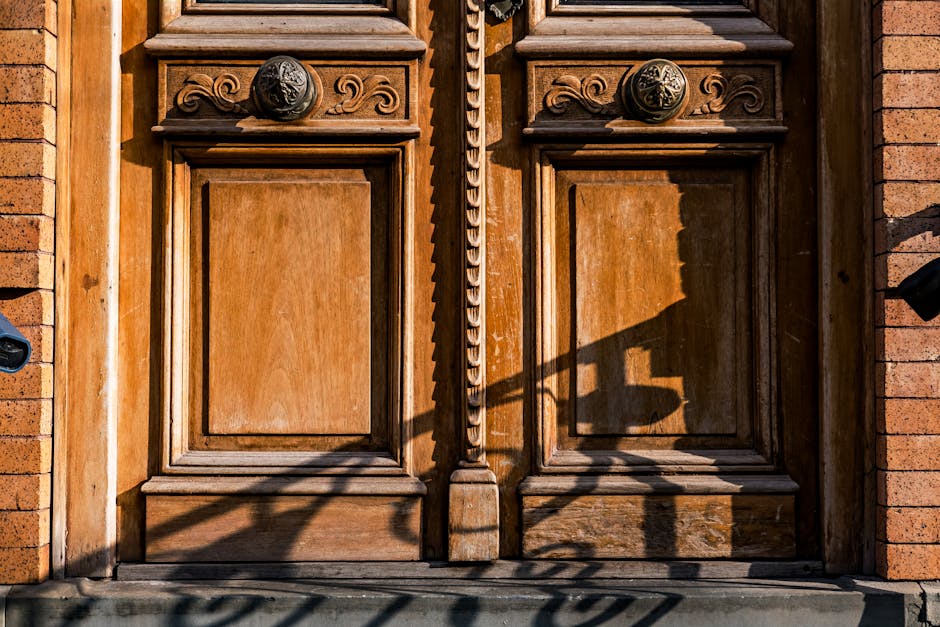 Beautifully crafted vintage wooden door featuring ornate carvings and warm textures in natural light.
